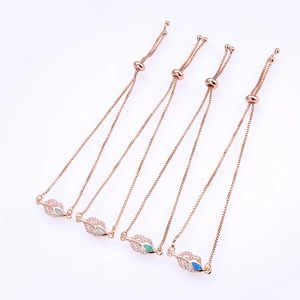 Detail of rose gold leaf bracelets with white, green, and blue opal stones