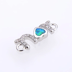 Macro detail of MOM heart opal connector with sparkling cubic zirconia for DIY jewelry