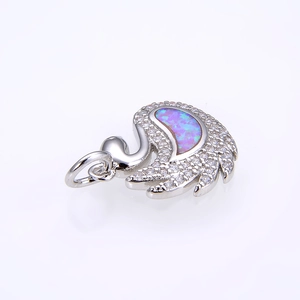 Detail of swan pendant with opal stone inlay and shimmering white zircon accents