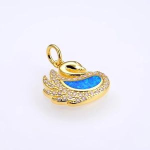 Detailed view of swan pendant with blue fire opal inlay and sparkling crystals