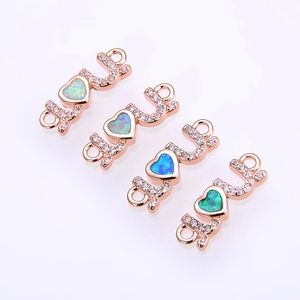 Close-up of rose gold LOVE connectors with colorful opal hearts and zircon stones