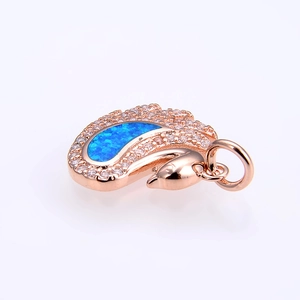 Detailed side view of swan-shaped rose gold pendant featuring vibrant blue opal stones