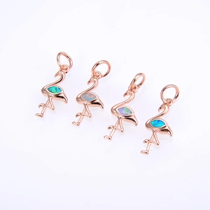 Detail of four rose gold flamingo pendants with iridescent opal inlay and top rings