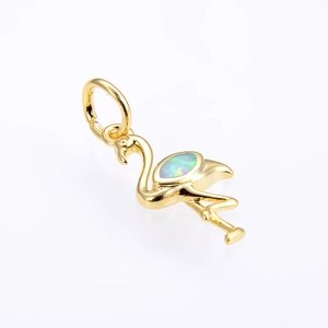 Macro shot of gold flamingo pendant featuring a vibrant blue oval opal gemstone inlay