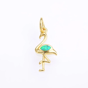 Macro view of a gold flamingo pendant with sparkling green-blue opal stone inlay
