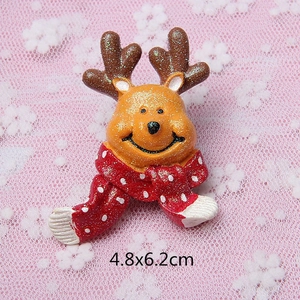 Close-up of a sparkling gold reindeer resin charm with a red scarf, sized 4.8x6.2cm
