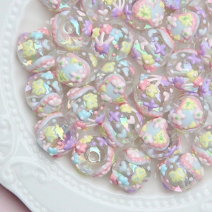 Close-up of DIY acrylic beads with colorful floral patterns and iridescent finish