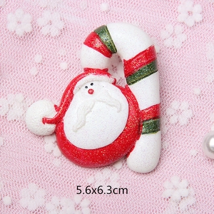 Detailed view of Santa and candy cane resin decoration with glitter finish and 5.6x6.3cm size