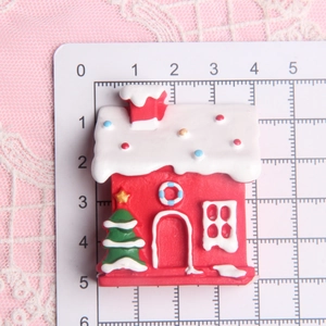Red Christmas cottage resin miniature with snow roof on measuring board for DIY crafts