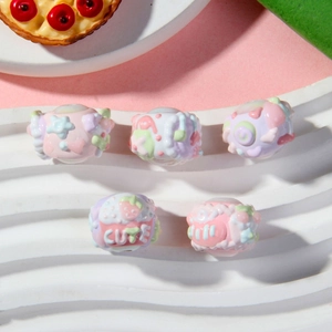 Detail of 5 macaron-colored resin barrel beads with 3D fruit and heart relief patterns