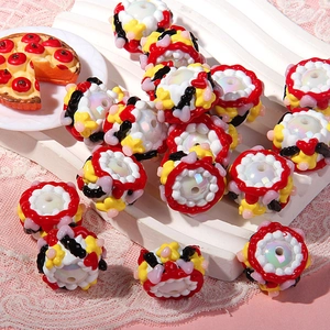 Detailed view of cake-themed resin beads with 3D fruit designs for DIY jewelry projects