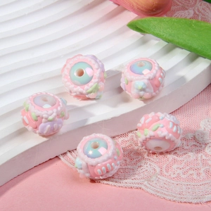 Detailed view of 3D floral beads with pastel pink finish and iridescent pearl centers