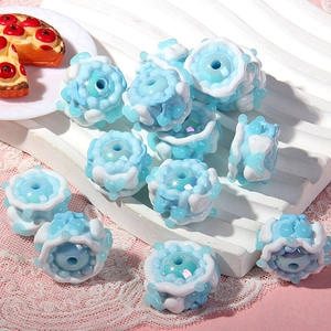 Macro detail of blue and white acrylic flower beads for DIY jewelry making
