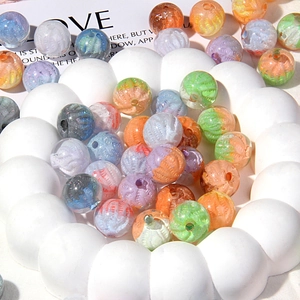Macro detail of artistic acrylic beads with spiral oil painting texture for DIY jewelry