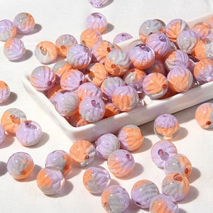 Macro detail of purple and orange textured acrylic beads with vein patterns for DIY crafts