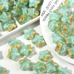 Detalle de cuentas de estrella verde menta con purpurina dorada para llaveros