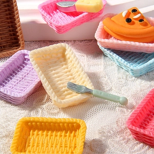 Macro view of miniature resin picnic baskets with colorful cakes and tiny forks
