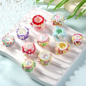Detailed view of colorful 3D resin beads with flower and cake shapes for DIY crafts