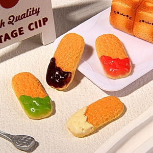 Macro view of miniature colorful resin biscuit models and cute cat toast figurines