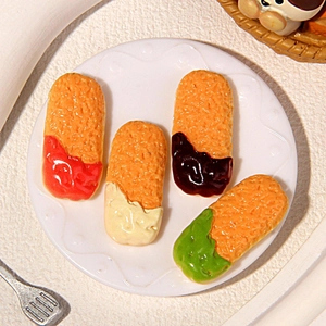Miniature fried chicken food models with various sauces on a small white plate