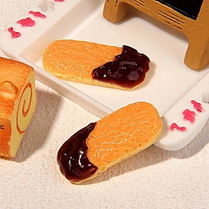 Miniature finger biscuits with chocolate coating on a floral tray for dollhouse decor