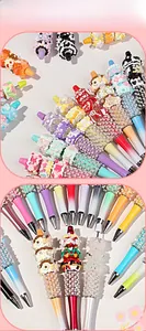 Detailed close-up of DIY beaded pens with resin charms and colorful cream clay textures