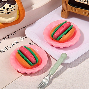 Macro shot of miniature hot dog models with tiny pink trays for DIY resin crafts