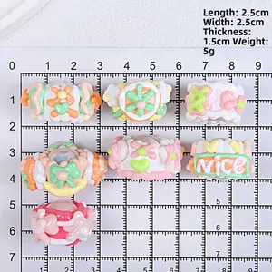 Detailed view of DIY macaron resin beads with nice text and flowers on measuring board