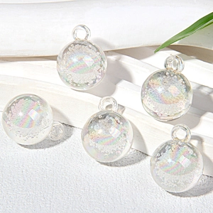 Macro detail of five 15mm holographic bubble glass beads with metal hanging loops