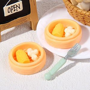 Detailed macro view of miniature dollhouse food set with resin corn and steamer baskets