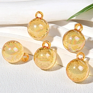 Close-up of 15mm golden bubble beads with iridescent foil inside on white steps