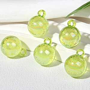 Macro detail of 15mm light green bubble glass beads with iridescent sequins for DIY crafts