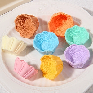 Colorful floral resin miniature baskets in various candy colors on a ceramic plate