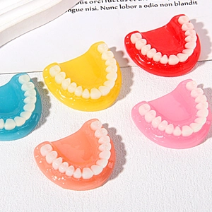 Macro detail of colorful resin tooth charms for DIY keychains and Halloween decorations
