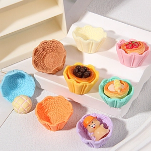 Miniature resin food models with colorful fruit tarts and cute pig figurine display