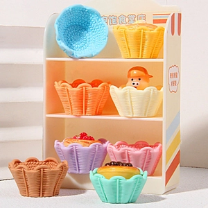 Detailed display of colorful miniature resin dessert models on a white tiered stand