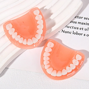 Detailed view of realistic resin dental model pendants with gums for DIY accessories