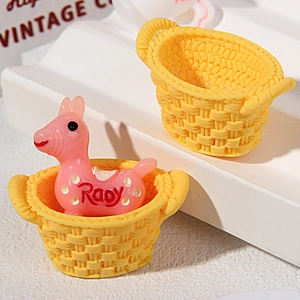 Detailed view of miniature yellow resin baskets and a tiny pink horse for DIY micro crafts