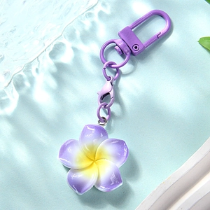 Detail of gradient purple plumeria flower keychain with matching lacquered metal hardware