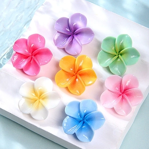 Colorful resin plumeria flower charms set in seven vibrant gradient shades for DIY crafts