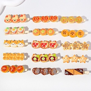 Detailed grid of fifteen resin hair clips featuring Japanese cartoon food and animal shapes