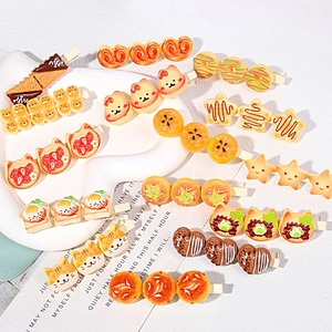 Detailed view of various cute resin food-shaped hair clips including donuts and waffles