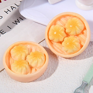 Macro shot of miniature Chinese soup dumplings in resin steamers with glossy finish