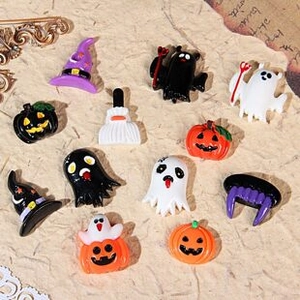 Flat lay of 3D miniature resin Halloween charms including pumpkins, ghosts and witch hats