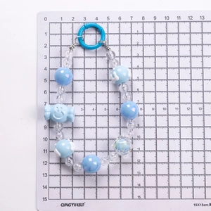 Blue and white beaded phone charm with gummy bear pendant and round carabiner clip