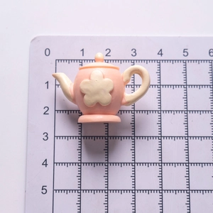 Miniature pink resin teapot accessory for dollhouse DIY craft with yellow flower detail
