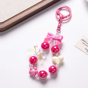 Detail of candy-colored beaded phone chain with pink bow and floral accents