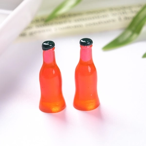 Macro shot of miniature resin soda bottles for DIY dollhouse crafts and jewelry