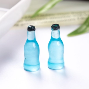 Macro shot of two miniature translucent blue resin soda bottles for dollhouse decor