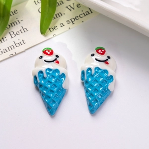 Close-up of resin ice cream cone charms with smiling faces and red strawberry details
